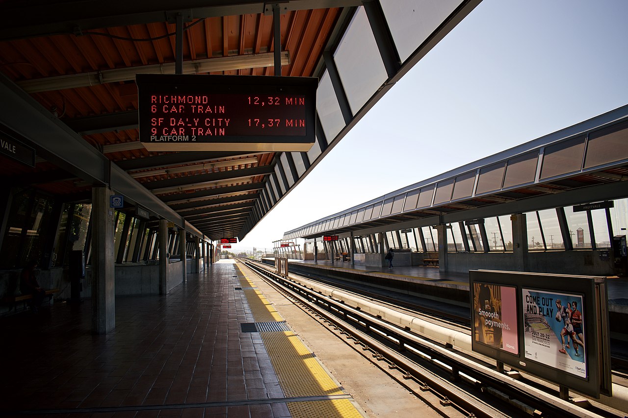 Fruitvale BART station with platforms, canopies, and neighborhood buildings